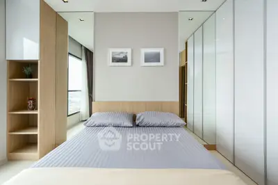Modern bedroom with sleek design, large windows, and ample storage space.