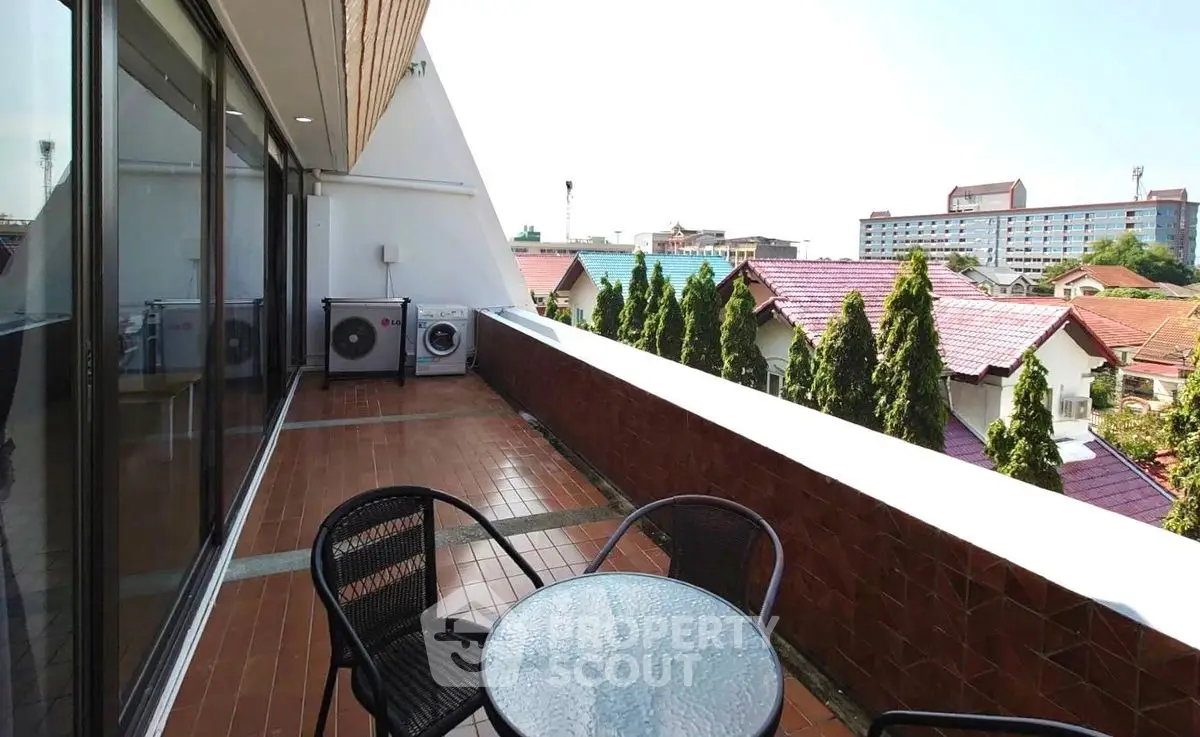 Spacious balcony with seating and city view, perfect for relaxation and entertaining.