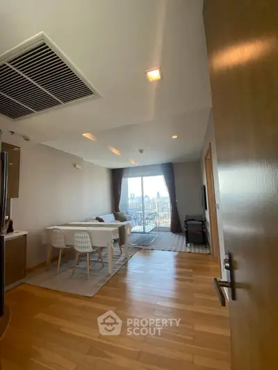 Spacious modern living room with city view, open layout dining area, and elegant wooden flooring.