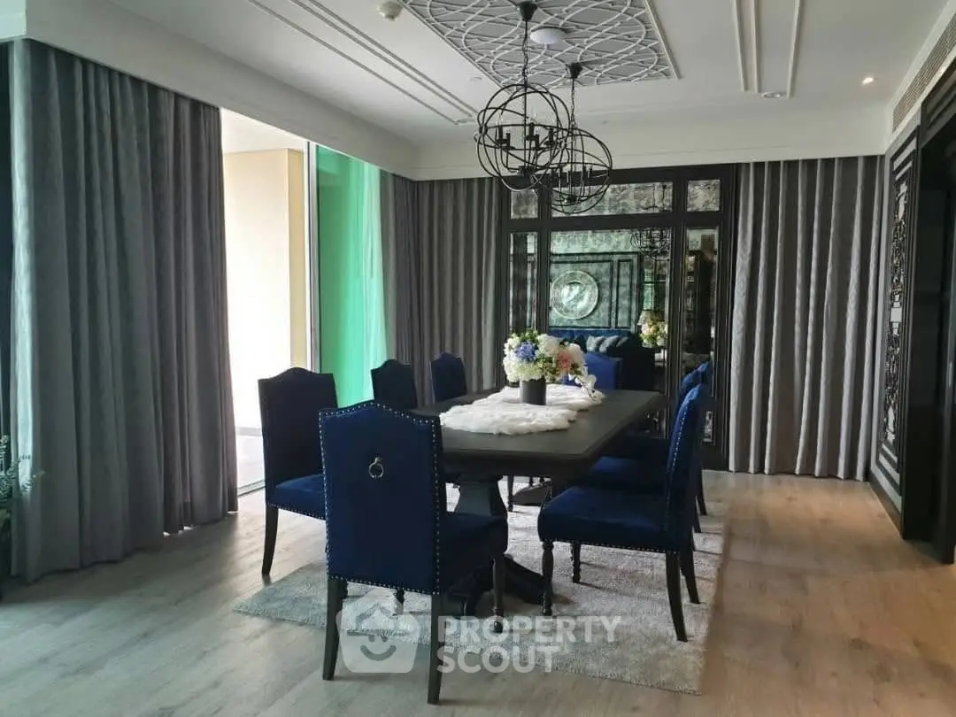 Elegant dining room with stylish decor and modern chandelier in luxury home.