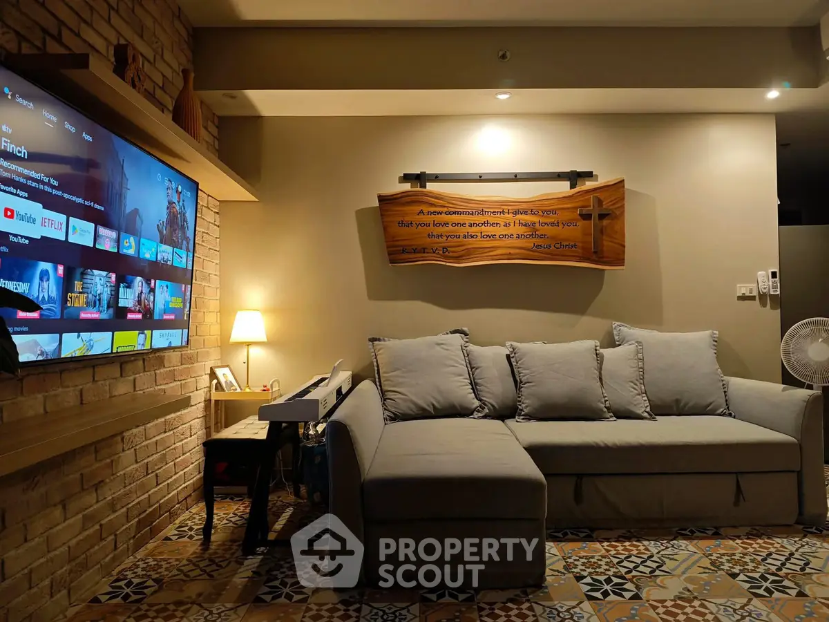 Cozy living room with modern sofa and wall-mounted TV, perfect for relaxation.