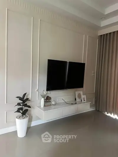 Modern living room with wall-mounted TV and elegant decor