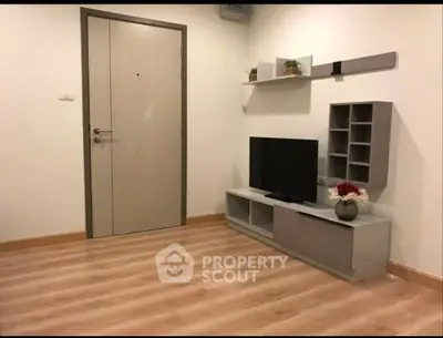 Modern living room with sleek TV unit and wooden flooring