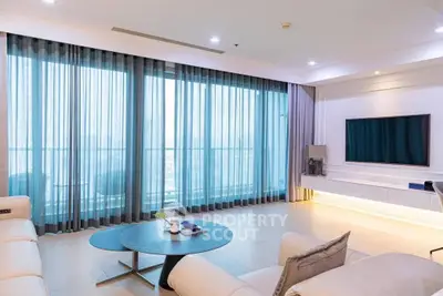 Spacious modern living room with large windows and elegant decor