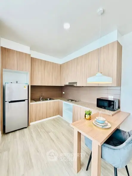 Modern kitchen with sleek wooden cabinets and breakfast bar