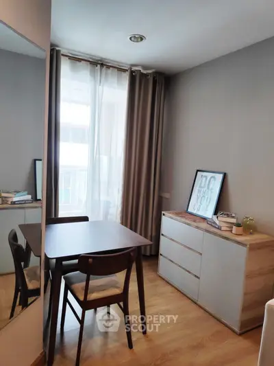 Cozy study area with modern furniture and natural light in a stylish apartment.