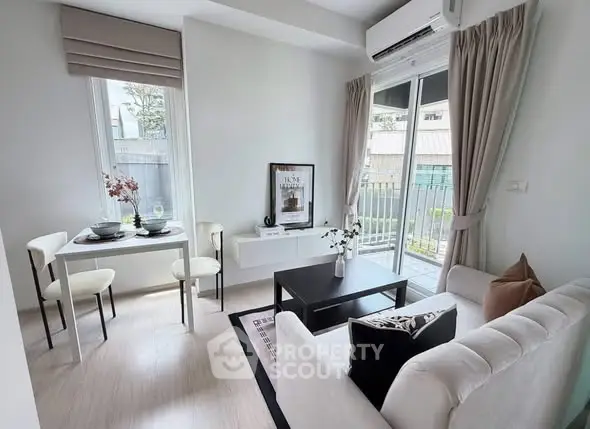 Modern living room with sleek furniture and balcony access in a stylish apartment.