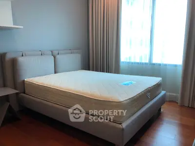 Spacious bedroom with modern bed and natural light