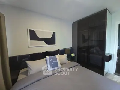Modern bedroom with sleek black wardrobe and stylish decor