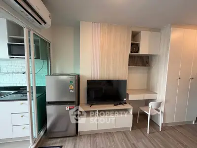 Modern living room with sleek furniture and open kitchen layout in stylish apartment.