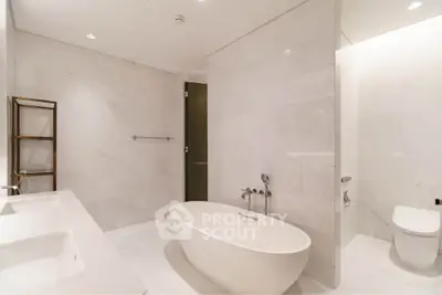 Luxurious modern bathroom with freestanding bathtub and elegant marble finishes.