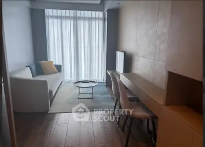 Modern living room with sleek furniture and large window, perfect for urban living.