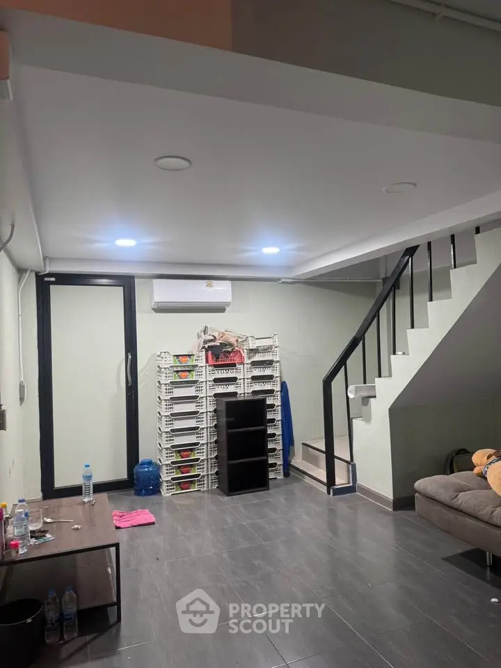 Modern living room with staircase and minimalist decor