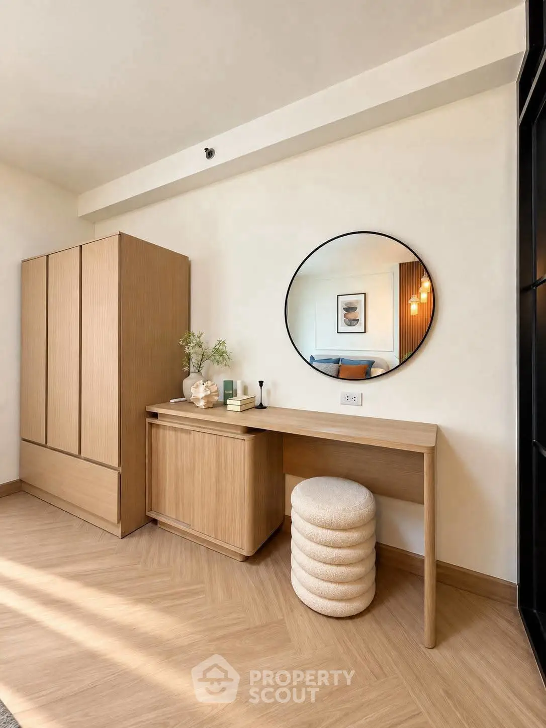 Stylish bedroom with modern wooden furniture and round mirror