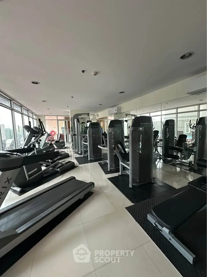 Modern gym with state-of-the-art fitness equipment in a residential building.