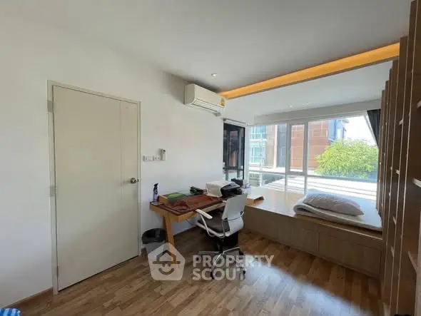 Bright study room with large window and modern furnishings