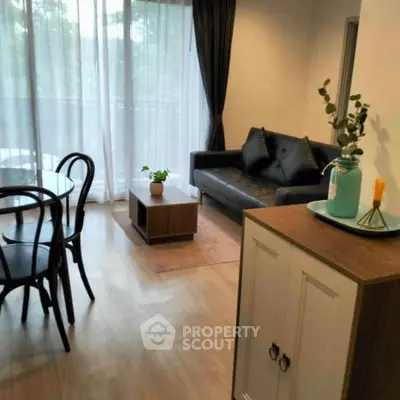 Modern living room with elegant decor and large windows offering natural light.