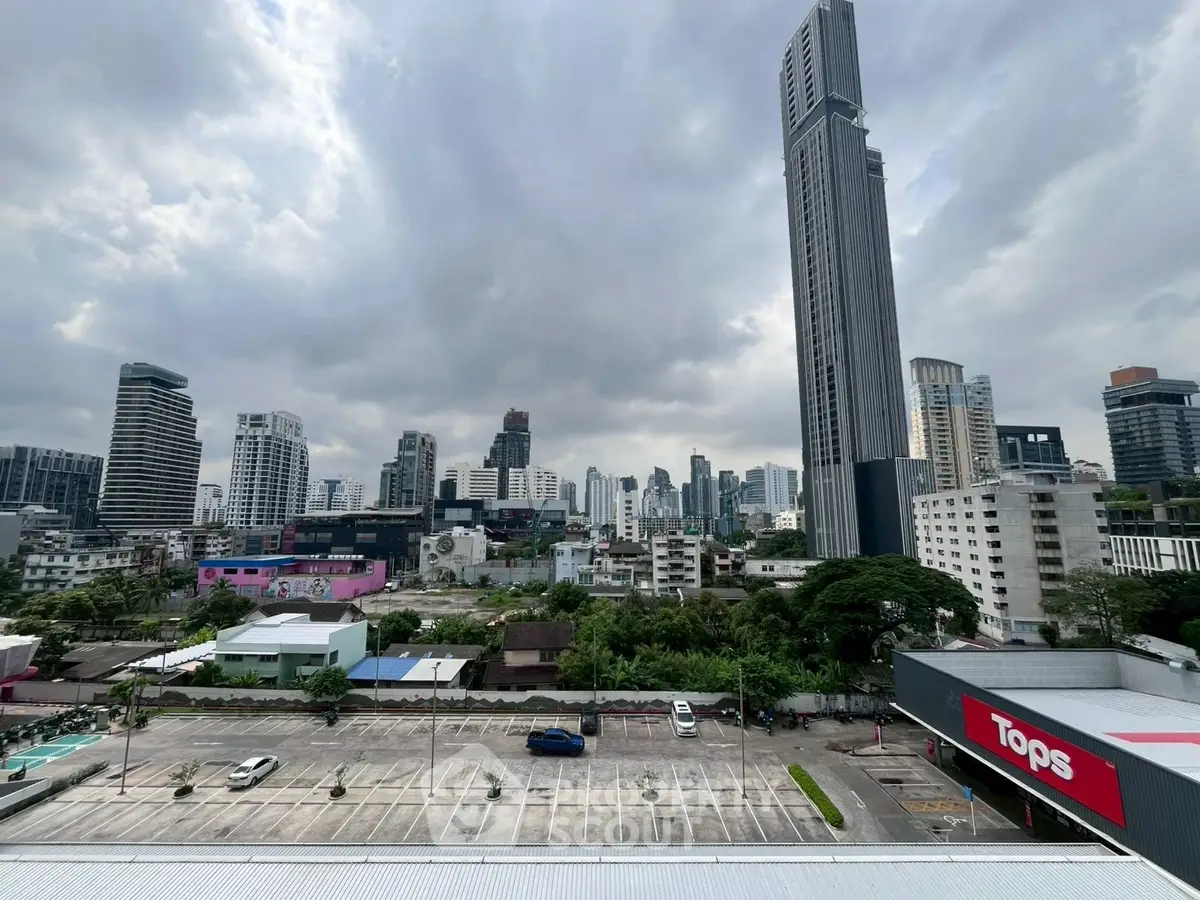 Stunning cityscape view showcasing modern skyscrapers and urban skyline under dramatic cloudy skies.