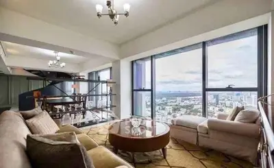 Luxurious living room with panoramic city views and elegant furnishings.