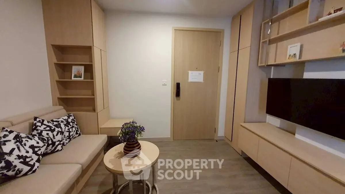 Modern living room with stylish furniture and wall-mounted TV