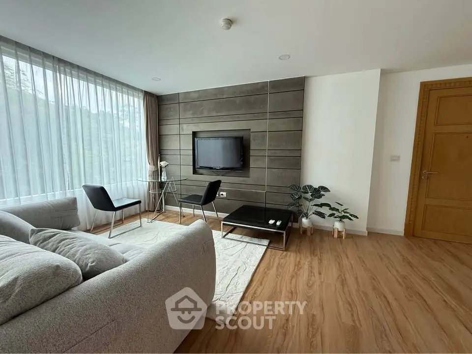 Modern living room with stylish decor and large window for natural light
