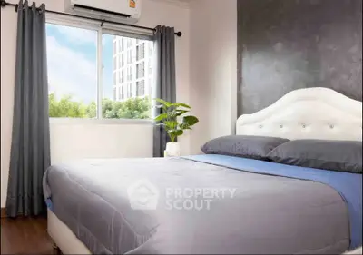Modern bedroom with stylish decor and large window offering natural light and city view.