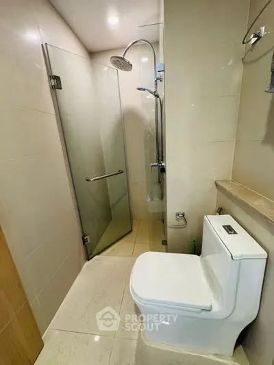 Modern bathroom with glass shower and sleek toilet design