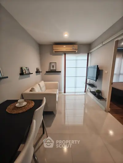 Modern living room with sleek furniture and natural light, perfect for cozy urban living.