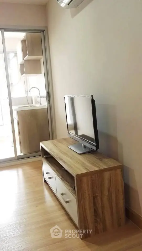 Modern living room with sleek TV stand and open kitchen view
