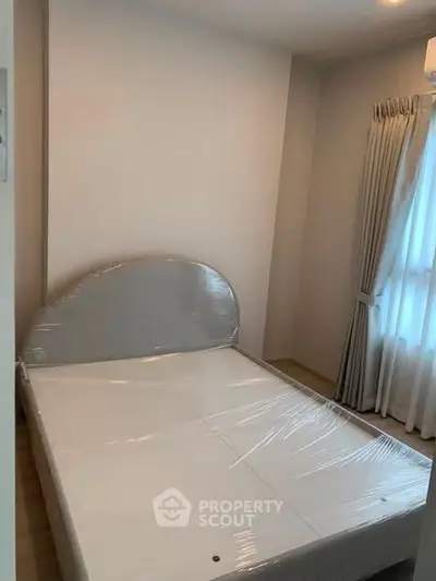Cozy bedroom with natural light and minimalist decor, perfect for relaxation and comfort.