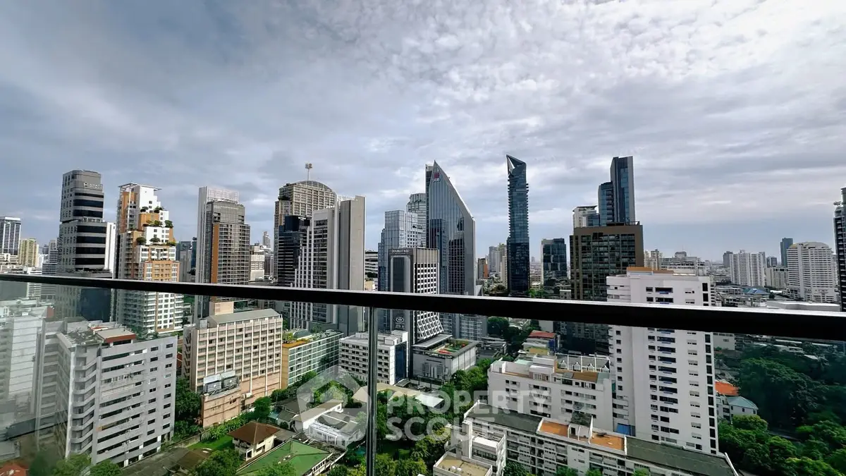 Stunning city skyline view from a high-rise balcony, showcasing modern architecture and lush greenery.