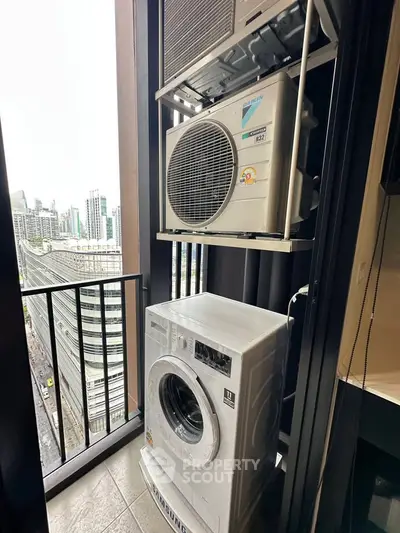 Modern high-rise apartment balcony with washing machine and city view.