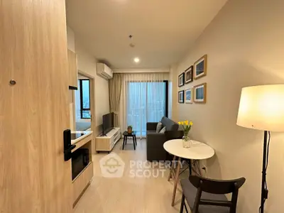 Modern living room with cozy decor and city view, featuring a comfortable sofa and stylish furniture.