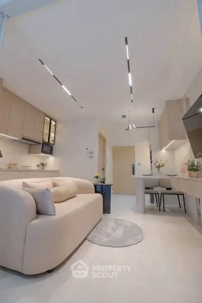 Modern living room with sleek furniture and open kitchen layout