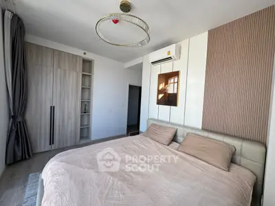 Modern bedroom with stylish decor, featuring a cozy bed, built-in wardrobe, and elegant lighting.