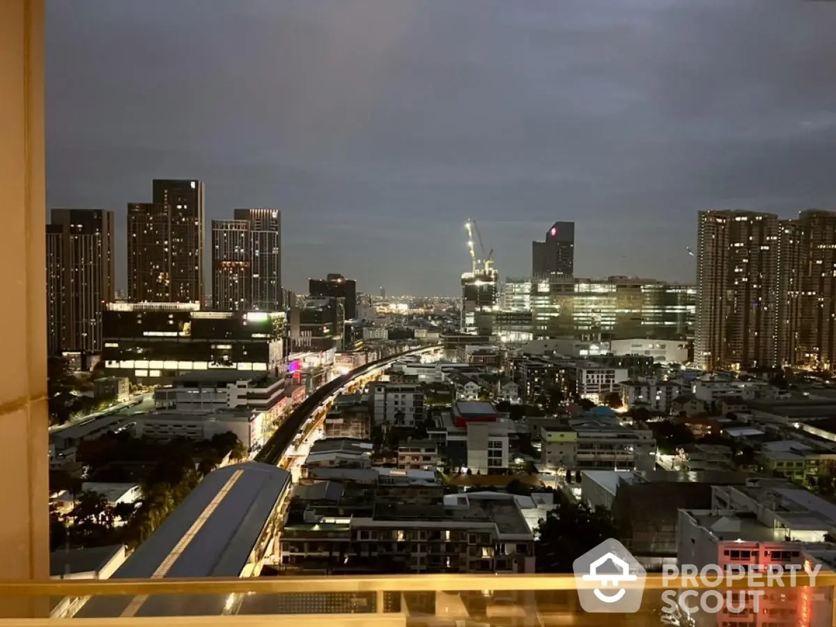 Stunning cityscape view from high-rise balcony at dusk, showcasing urban skyline and vibrant city lights.