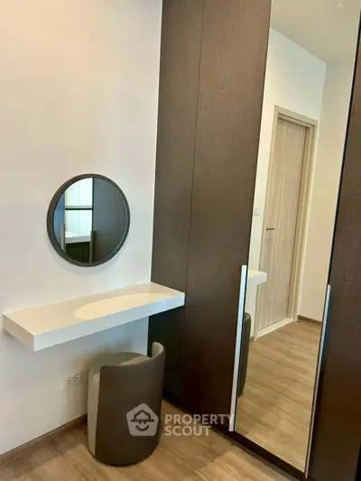 Modern bedroom with stylish vanity and mirrored wardrobe