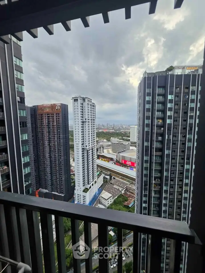 Stunning cityscape view from a high-rise balcony, showcasing modern skyscrapers and urban skyline.