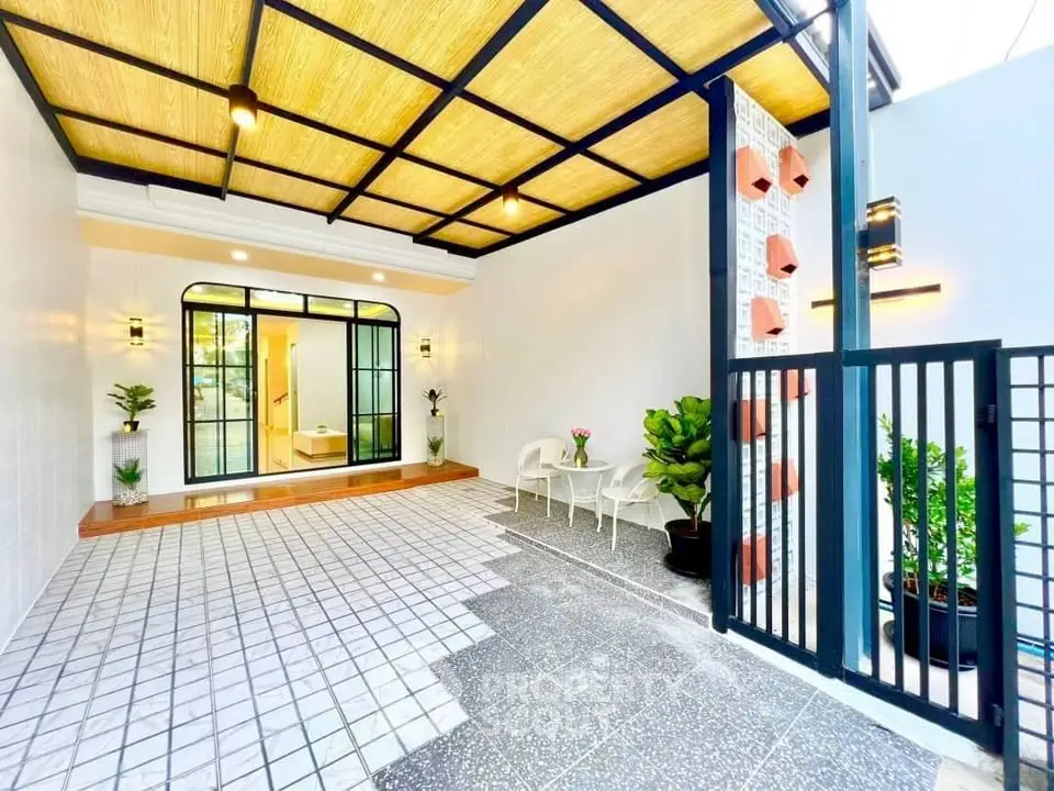 Charming modern entrance with stylish lighting and cozy seating area.