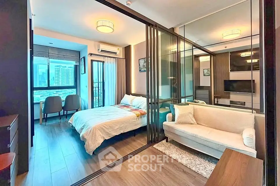 Modern apartment with glass partition, cozy bedroom, and stylish living area with city view.