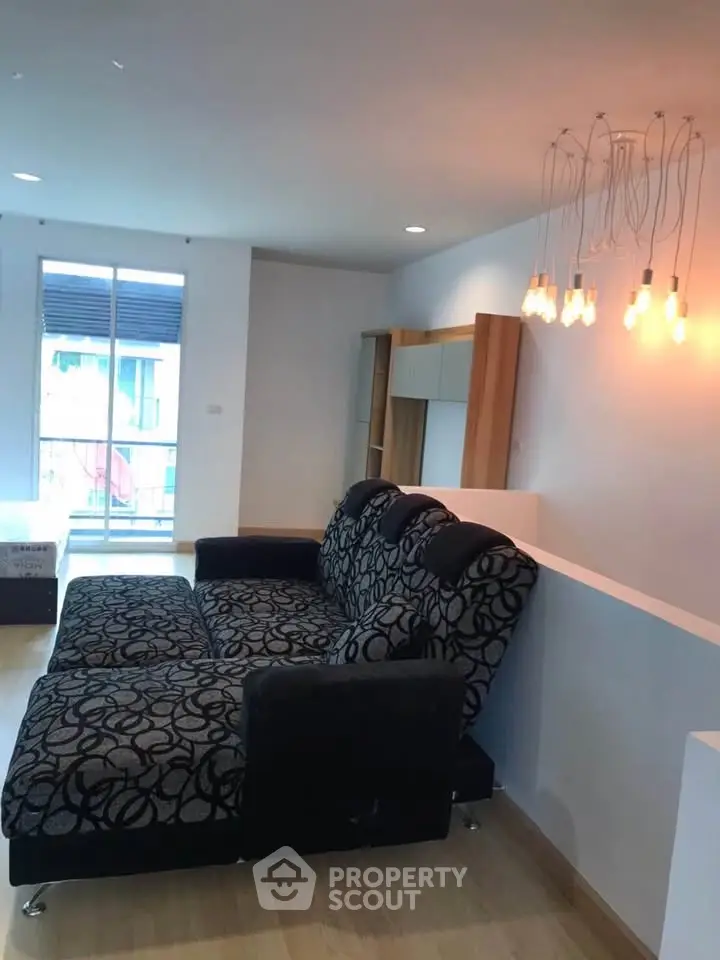 Modern living room with stylish sofa and unique lighting, perfect for relaxation and entertaining.