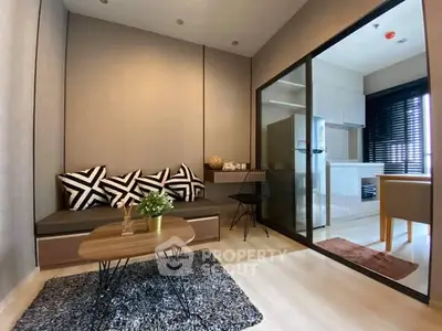 Modern living room with stylish decor and open kitchen layout in a cozy apartment.