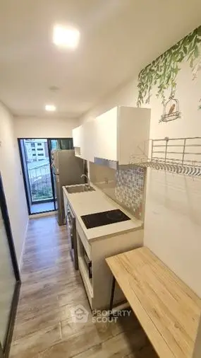 Sleek modern kitchen with open layout, featuring stylish backsplash, ample cabinetry, and a cozy dining nook, perfect for urban living.