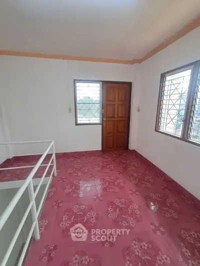 Charming interior space with vibrant pink floral tiles and wooden door, perfect for creative design ideas.