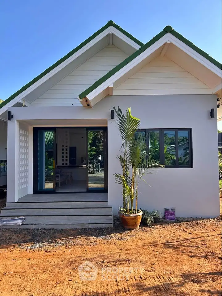 Charming modern bungalow with green roof and inviting entrance