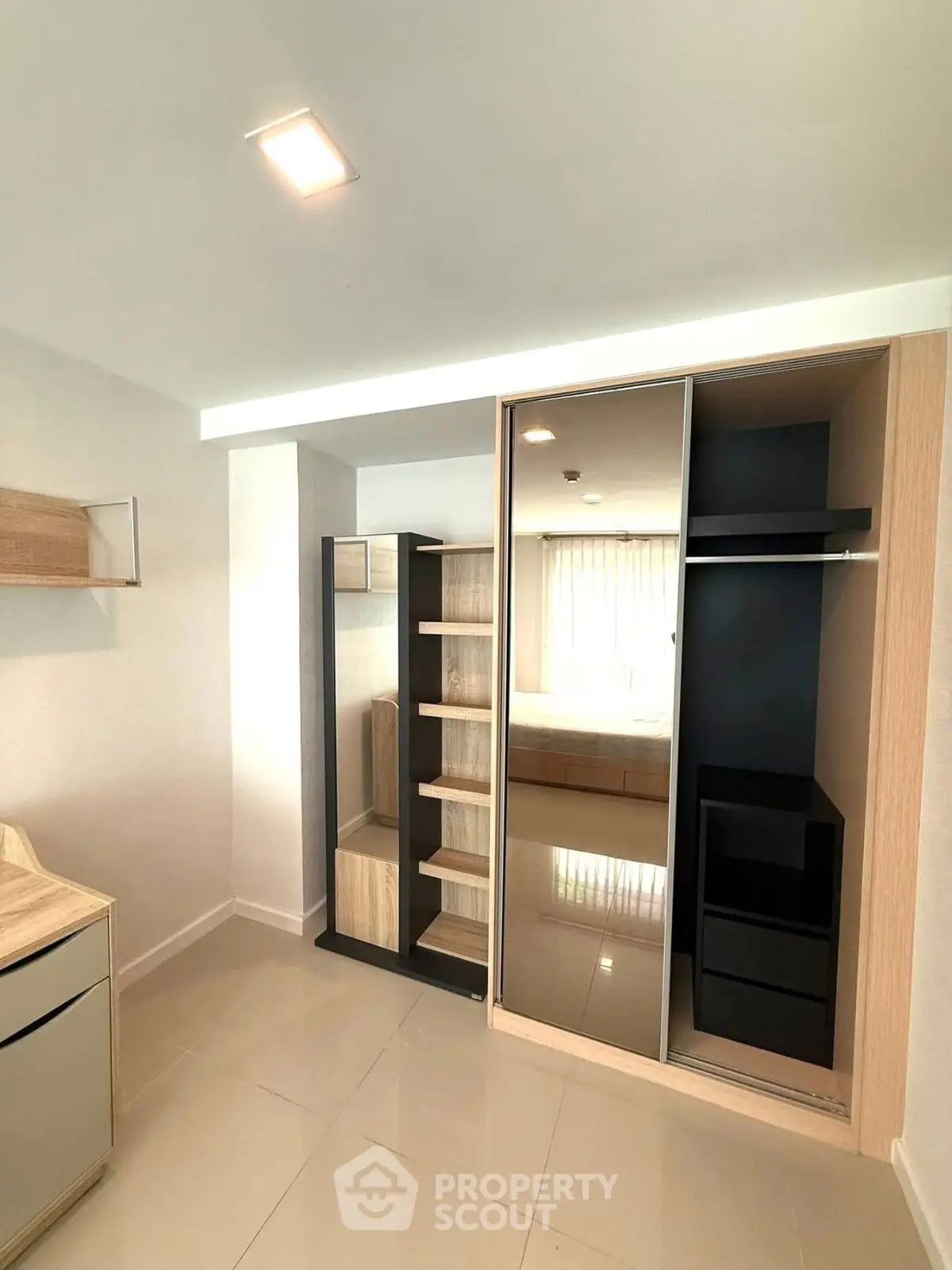 Modern bedroom with sleek wardrobe and ample natural light
