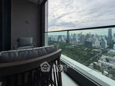 Stunning high-rise balcony with panoramic city skyline view, perfect for relaxation and enjoying urban living.