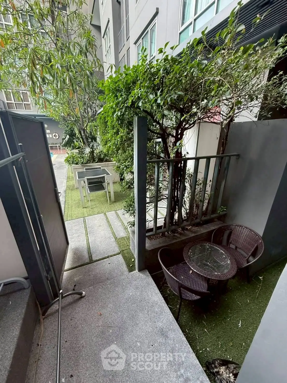 Charming garden patio with outdoor seating in modern apartment complex