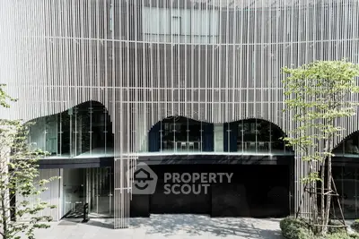 Modern architectural building facade with unique vertical slats and glass windows.