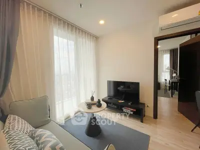 Modern living room with stylish decor and natural light in a contemporary apartment.